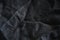 Closeup of dark linen crumpled fabric