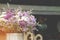 Closeup of Decorative Corrugated Zinc Vase with Violet Flowers