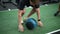 Closeup of dedicated beginner sportsman training using heavy fitness ball in gym. Motivated athlete doing strength