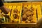 Closeup deep fried leg pigs display on the wooden tray at night flea market