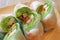 Closeup delectable fresh vegetables with prawn spring rolls on a wooden plate