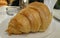 Closeup of delicious croissant served on a plate in a restaurant as a tasty breakfast