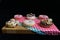 Closeup of delicious fresh glazed donuts on chequered tablecloths on a cutting board