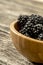 Closeup of delicious ripe blackberries heaping in a wooden bowl