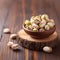 Closeup of delicious roasted salted pistachios on wooden background