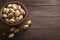 Closeup of delicious roasted salted pistachios on wooden background