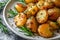 closeup of delicious rustic potatoes with rosemary on a white plate