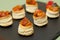 Closeup of delicious stuffed vol-au-vent on a black serving board on the table