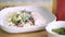 Closeup delicious vegetable and meat salad on white plate 4k