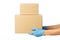 Closeup delivery man hand in medical gloves holding cardboard boxes isolated on white background