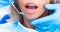 Closeup of dentist examinating girl