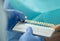Closeup of dentist hand with blue latex gloves is holding a tooth veneer scale chart