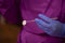 Closeup of a dentist wearing gloves and holding a dental mouth mirror