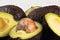 Closeup detail of avocado - Hass / Bilse variety - pit visible in halved pears.