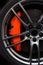 Closeup detail on a big orange sport break, on a sport tire