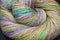 Closeup detail of colourful ball of wool, skeins of organic handspun merino sheep wool, spun on a traditional spinning wheel