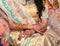 Closeup detail of Indian bride with henna tattoos wearing beautiful golden color garments