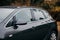 Closeup detail of a luxurious grey car parked outdoors