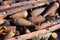 Closeup detail of a pile of rusty grenades, bombs and unexploded ordnance in rural Laos