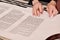 Closeup detail of a Rabbi writing a Torah manuscript scroll