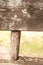 Closeup detail of a weathered and natural faded rural wooden bench neglected in the countryside