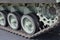 Closeup detailed view of a armoured tank track with belt and roadwheels