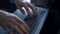 Closeup director hands work laptop at dark office. Unknown man typing keyboard