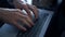 Closeup director hands work laptop at dark office. Unknown man typing keyboard