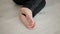 Closeup dirty heels of child lying on the floor on a white parquet floor in black jeans