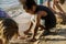 Closeup of diverse kids playing with the sand together at the be