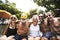 Closeup of diverse senior adults sitting by the pool enjoying su