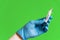Closeup of doctor hand with gloves holding covid-19 vaccine syringe on green colorful background. concept of science and