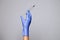 Closeup doctor or nurse hand in rubber latex medical purple glove holding a transparent syringe with sharp needle. Ð¡oncept