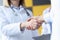 Closeup of doctor and patient handshake in clinic