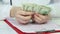 Closeup of doctor\'s hands counting dollars, corrupt health care system, bribery