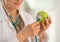 Closeup on doctor using stethoscope on apple