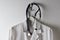 Closeup Doctors White Lab Coat Hanging on a Hook with Stethoscope, horizontal