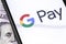 Closeup dollars and smartphone with Google Pay logo on the screenwallet service by