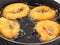 Closeup of doughnuts boiling