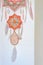 Closeup dreamcatcher with two God`s eye mandalas and feathers on wall background