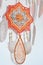 Closeup dreamcatcher with two God`s eye mandalas and feathers on wall background