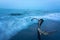 Closeup of driftwood on the shore water waves flooding it with long exposure effect