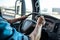 closeup of drivers hand on truck steering wheel