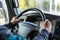 closeup of drivers hand on truck steering wheel