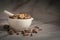 Closeup of Dry Vridha Daru barks, in white ceramic mortar and pestle.