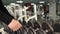 Closeup of dumbbells row, bodybuilding trainer picks gym equipment for beginner