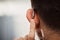 Closeup of ear, hearing aid and man with disability from the back for support, improve listening or amplifier with