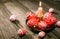 Closeup Easter red eggs with folk white pattern lay around on brass candlestick with burning candle and scattered eggs on rustic t