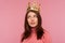 Closeup egoistic self confident woman wearing golden crown on head, looking with arrogance, pretending to be queen, leadership