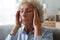 Closeup elderly woman massaging temples reduces intense headache